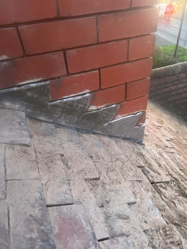 This is a photo of new leadwork being installed around an old chimney. Works carried out by Wingerworth Roofing Repairs