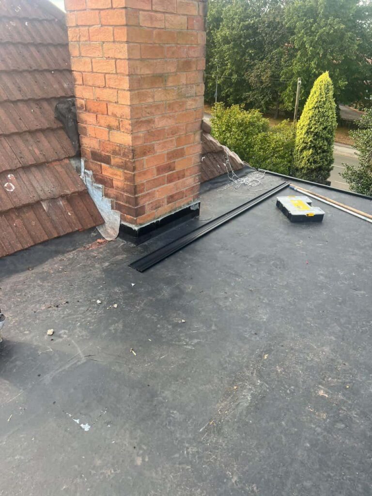 This is a photo of a flat roof which has just been repaired, there is also a chimney stack and some leadwork has also been dressed. Works carried out by Wingerworth Roofing Repairs